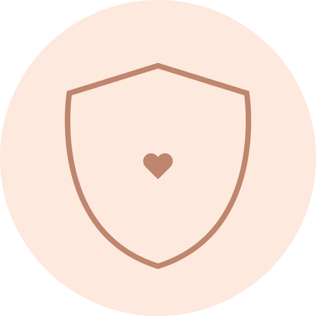 Minimalist line icon of a shield with a small heart at its center inside a circle, in a muted rose outline on a pale peach background.