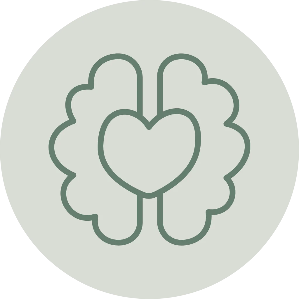 Minimalist line icon of a brain with a heart shape at its center inside a circle, in a muted green outline on a light sage green background.
