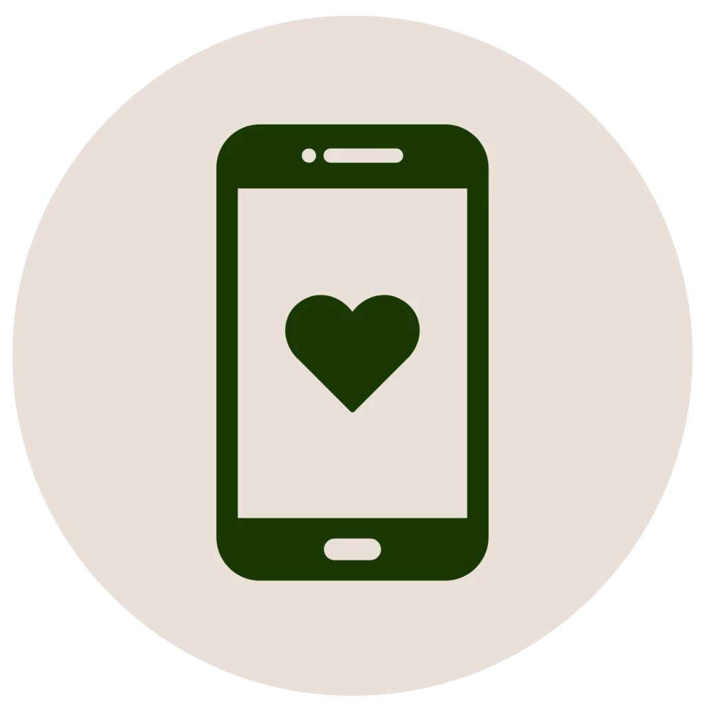 Minimalist flat icon of a smartphone with a heart on the screen inside a circle, in a dark green silhouette on an off-white background.
