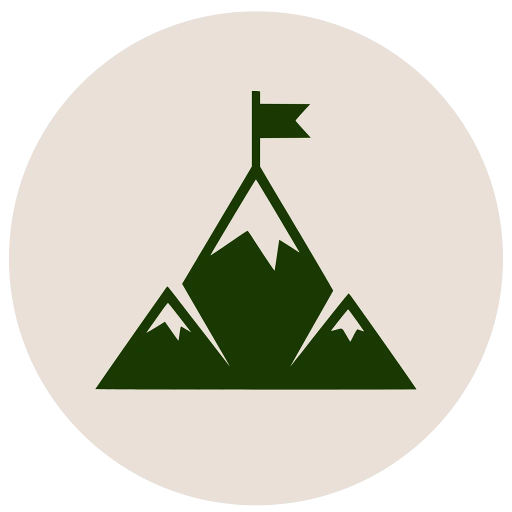 Minimalist flat icon of mountain peaks with a flag at the highest summit inside a circle, in a dark green silhouette on an off-white background.