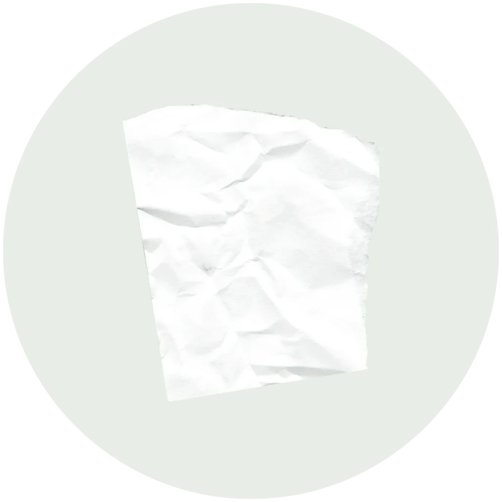 A piece of crumpled white paper centered on a light gray circular background.