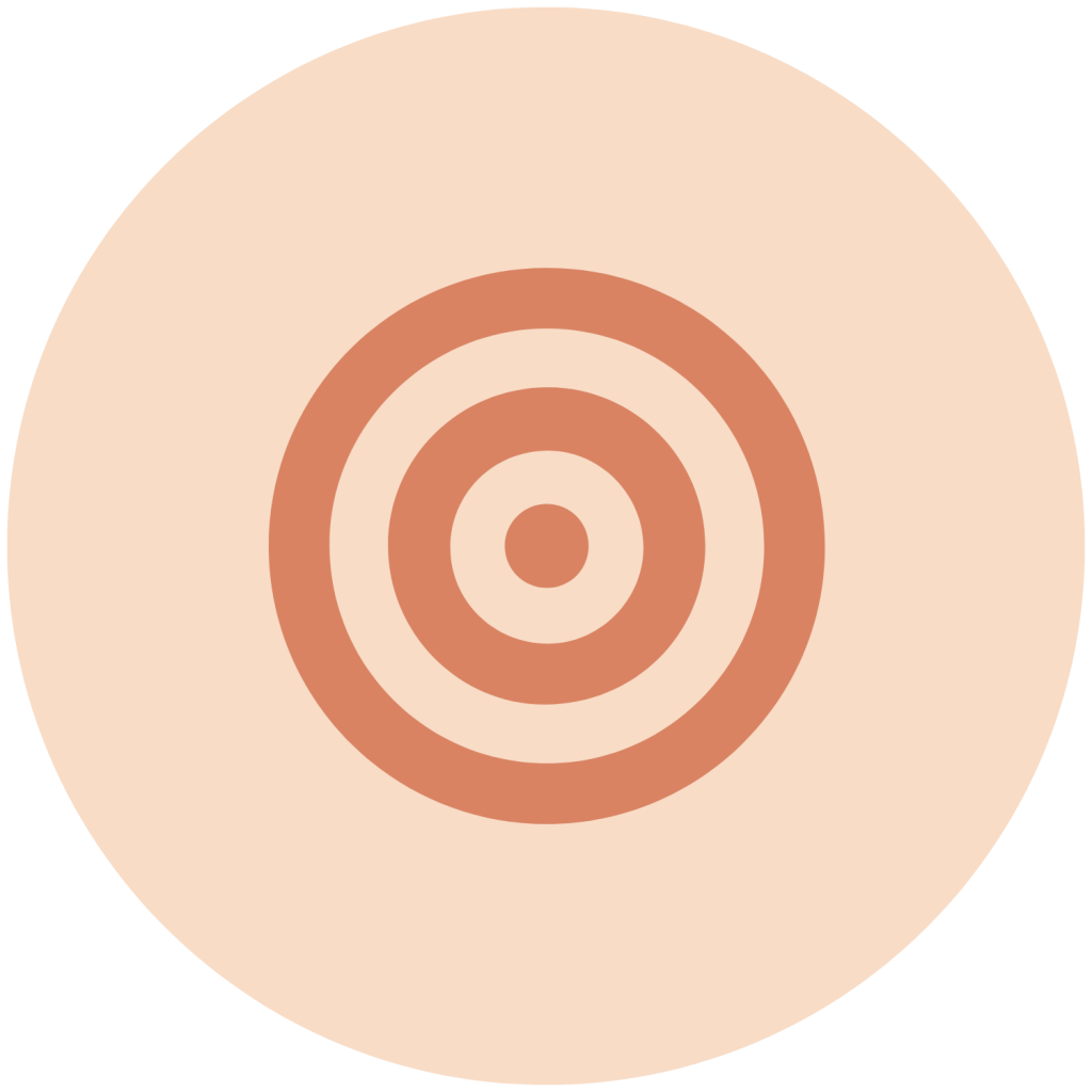 A bullseye target with orange rings on a light pinkish-beige circular background.