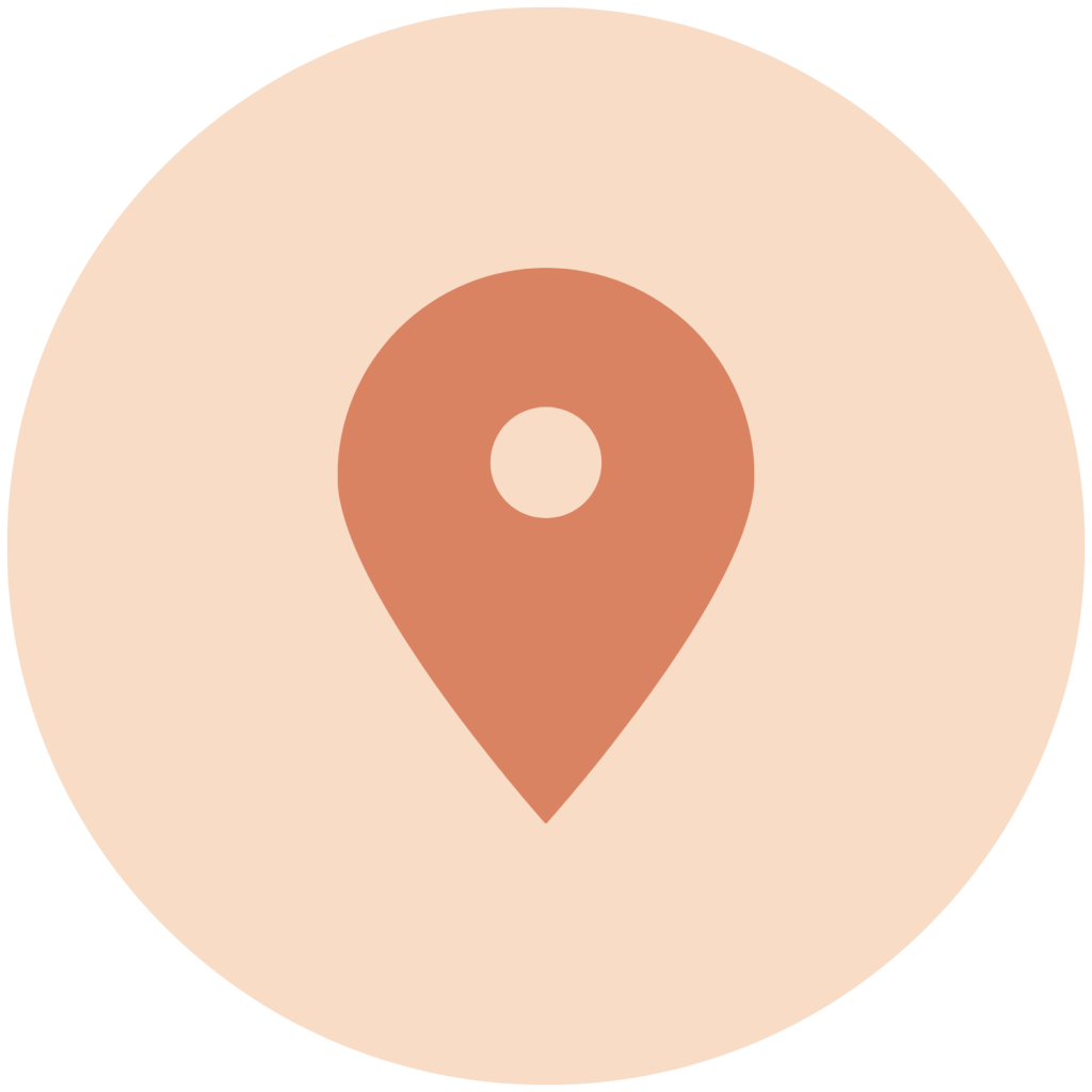 A pin icon on a light pinkish-beige circular background.